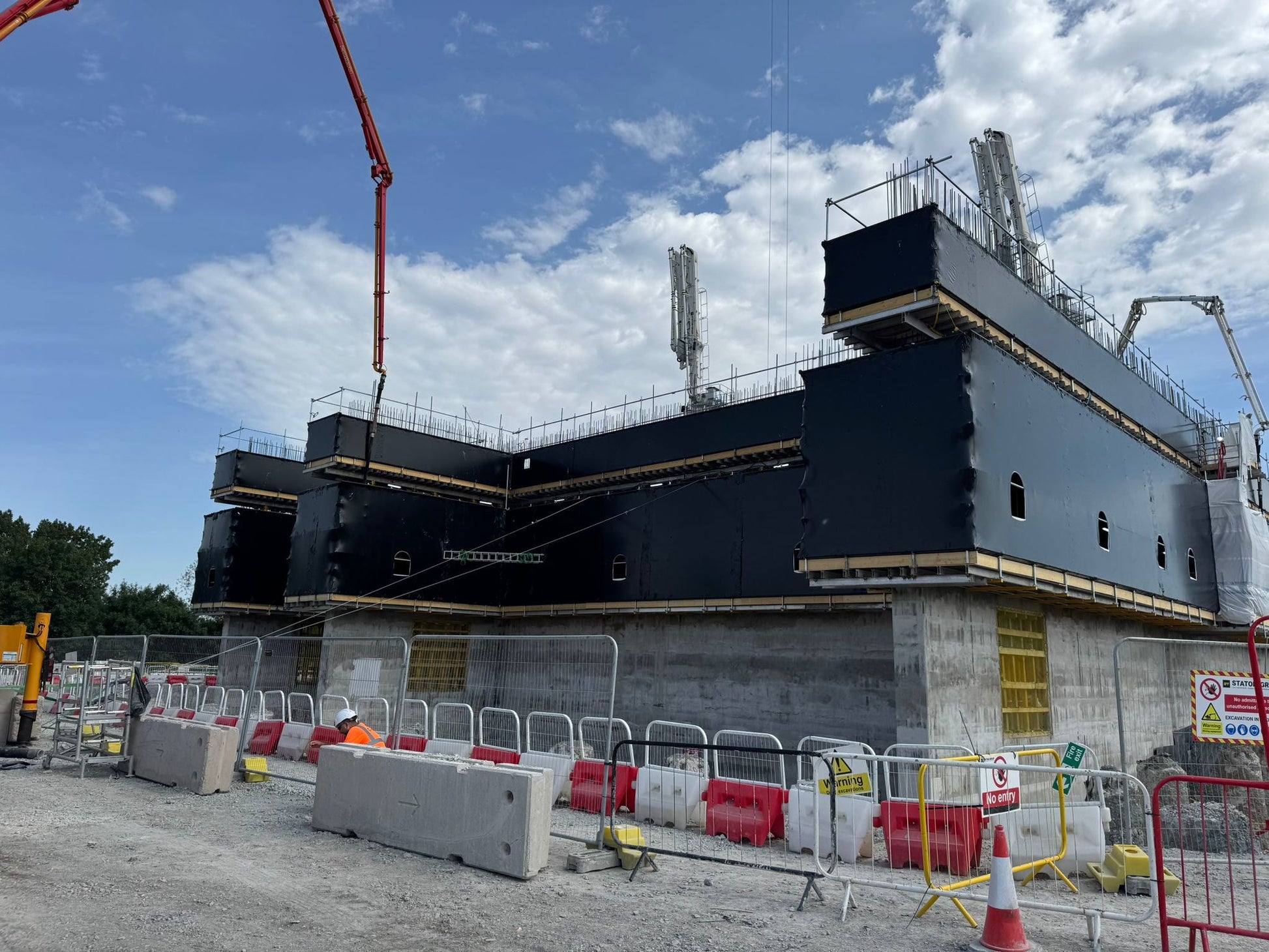 Concrete structure protected with black 300 FR Rhino Shrink Wrap during construction