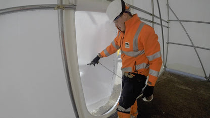 zipped door being installed in shrink wrap - inside view