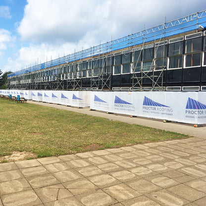Printed Debris Netting with company logo on Heras fencing on construction site.